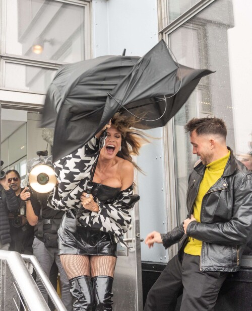 Mandatory Credit: Photo by Lev Radin/Shutterstock (15642319am)Heidi Klum visits the Empire State Building in New York, NY on October 30, 2025 for ceremonial lighting in orange to celebrate Halloween. On the observation deck was heavy rain and strong wind as Heidi Klum struggle to hold an umbrella.Heidi Klum lights up the Empire State Building to celebrate Halloween, New York, United States - 30 Oct 2025/shutterstock_editorial_Heidi_Klum_lights_up_the_Empi_15642319am//2510311434