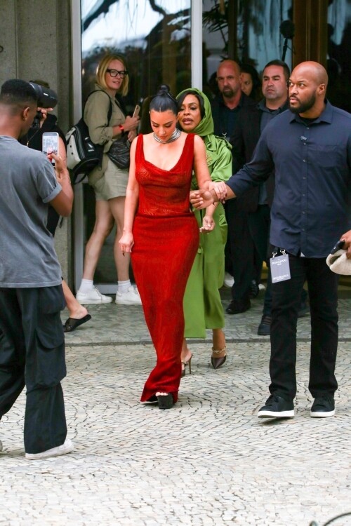*EXCLUSIVE* Rio de Janeiro, BRAZIL    Kim Kardashian was seen on the balcony of Rios Copacabana Palace with the cast of Alls Fair, looking stunning in a very long, red-hot dress before taking her heels for a perilous spin on the cobblestone streets below  where even her security appeared to need backup. The reality star, usually all smiles for the cameras, kept her head down as she focused on every careful step. Between the uneven terrain and the sweeping length of her gown, Kim had her hands (and heels) full as she navigated Rio in sky-high platforms.Pictured: Kim Kardashian, Niecey NashBACKGRID USA 11 NOVEMBER 2025 BYLINE MUST READ: Dilson Silva / BACKGRIDUSA: +1 310 798 9111 / usasales@backgrid.comUK: +44 208 344 2007 / uksales@backgrid.com*UK Clients - Pictures Containing ChildrenPlease Pixelate Face Prior To Publication*