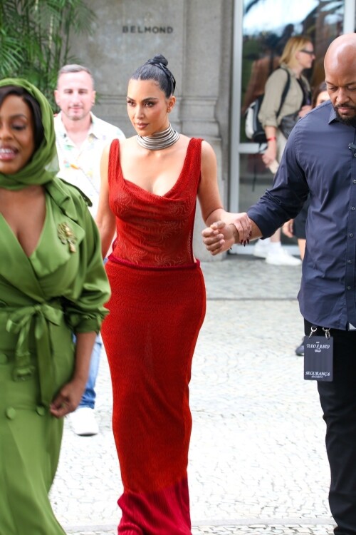 *EXCLUSIVE* Rio de Janeiro, BRAZIL    Kim Kardashian was seen on the balcony of Rios Copacabana Palace with the cast of Alls Fair, looking stunning in a very long, red-hot dress before taking her heels for a perilous spin on the cobblestone streets below  where even her security appeared to need backup. The reality star, usually all smiles for the cameras, kept her head down as she focused on every careful step. Between the uneven terrain and the sweeping length of her gown, Kim had her hands (and heels) full as she navigated Rio in sky-high platforms.Pictured: Kim Kardashian, Niecey NashBACKGRID USA 11 NOVEMBER 2025 BYLINE MUST READ: Dilson Silva / BACKGRIDUSA: +1 310 798 9111 / usasales@backgrid.comUK: +44 208 344 2007 / uksales@backgrid.com*UK Clients - Pictures Containing ChildrenPlease Pixelate Face Prior To Publication*